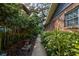 Walkway through lush side yard landscaping alongside brick home at 4426 Saxon Dr, New Smyrna Beach, FL 32169
