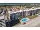 Aerial view of condo complex on the beach with a sparkling blue swimming pool at 4445 S Atlantic Ave # 804, Ponce Inlet, FL 32127