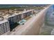Panoramic aerial view of oceanfront condo building featuring pools, lawn, and direct beach access at 4445 S Atlantic Ave # 804, Ponce Inlet, FL 32127