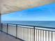Balcony view of ocean meeting the sandy shore below at 4445 S Atlantic Ave # 804, Ponce Inlet, FL 32127