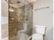 Bathroom featuring a tiled shower stall, toilet, and towel bar at 4445 S Atlantic Ave # 804, Ponce Inlet, FL 32127