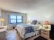 Comfortable bedroom showcasing a window with natural light and tiled flooring at 4445 S Atlantic Ave # 804, Ponce Inlet, FL 32127