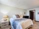 Cozy bedroom featuring bedside tables with lamps and tiled flooring at 4445 S Atlantic Ave # 804, Ponce Inlet, FL 32127
