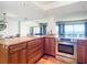 Modern kitchen featuring granite counters, stainless steel oven, and hardwood cabinets at 4445 S Atlantic Ave # 804, Ponce Inlet, FL 32127