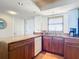 Well-lit kitchen with granite countertops, stainless steel dishwasher and hardwood cabinets at 4445 S Atlantic Ave # 804, Ponce Inlet, FL 32127