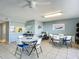 Spacious meeting room featuring tiled floors, ceiling fan, bright lighting, and kitchen view at 4445 S Atlantic Ave # 804, Ponce Inlet, FL 32127