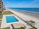 Oceanfront complex pool surrounded by lawn, beach, and seating with easy beach access at 4445 S Atlantic Ave # 804, Ponce Inlet, FL 32127