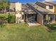 Exterior view of a home featuring a screen enclosed patio and well maintained lawn at 448 Shorewood Ln, New Smyrna Beach, FL 32168