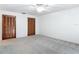 Bedroom with a ceiling fan, neutral walls, carpet flooring and wood closets at 448 Shorewood Ln, New Smyrna Beach, FL 32168