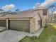 Charming townhome showcasing a two-car garage and stone accents at 448 Shorewood Ln, New Smyrna Beach, FL 32168
