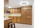 Kitchen highlighting wooden cabinets, a tiled backsplash, and a breakfast bar at 448 Shorewood Ln, New Smyrna Beach, FL 32168