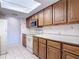 Kitchen showcasing wood cabinets, a microwave, and tiled flooring at 448 Shorewood Ln, New Smyrna Beach, FL 32168