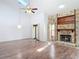 Open living area with stone fireplace, vaulted ceiling, and sliding door access to the outdoors at 448 Shorewood Ln, New Smyrna Beach, FL 32168