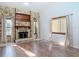 Inviting living room featuring stone fireplace and wood-look flooring and natural light at 448 Shorewood Ln, New Smyrna Beach, FL 32168