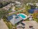 Aerial view of community pool, hot tub, tennis court, and ample parking at 448 Shorewood Ln, New Smyrna Beach, FL 32168
