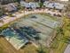 Aerial view of community tennis and shuffleboard courts, surrounded by lush landscaping at 448 Shorewood Ln, New Smyrna Beach, FL 32168