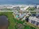 Aerial view featuring lush foliage, community pool, and convenient beach access at 4860 S Atlantic Ave # 1030, New Smyrna Beach, FL 32169