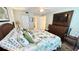 Inviting bedroom featuring a TV, closet, and ensuite bathroom, creating a comfortable and private retreat at 4860 S Atlantic Ave # 1030, New Smyrna Beach, FL 32169