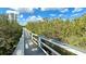 Enjoy a peaceful stroll on the community walkway, surrounded by lush greenery and natural beauty at 4860 S Atlantic Ave # 1030, New Smyrna Beach, FL 32169