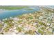 An overhead view of a community near the coast featuring serene waterways, residential streets, and tropical landscaping at 601 N Peninsula Ave, New Smyrna Beach, FL 32169