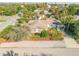 A charming single-story home featuring mature trees and tropical foliage, with a glimpse of the neighborhood beyond at 601 N Peninsula Ave, New Smyrna Beach, FL 32169