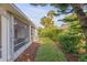 An exterior shot of a backyard featuring a screened-in porch and lush perimeter landscaping, offering privacy at 601 N Peninsula Ave, New Smyrna Beach, FL 32169