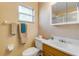 Bathroom featuring a vanity, mirror cabinet and toilet under a window at 601 N Peninsula Ave, New Smyrna Beach, FL 32169