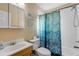 Bathroom featuring a vanity, mirror cabinet and bathtub and shower with shower curtain at 601 N Peninsula Ave, New Smyrna Beach, FL 32169