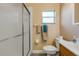 Bathroom featuring a glass enclosed shower, vanity with sink, and toilet at 601 N Peninsula Ave, New Smyrna Beach, FL 32169