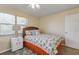 Bedroom featuring a bed, side table and windows with coverings at 601 N Peninsula Ave, New Smyrna Beach, FL 32169