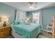 Bedroom featuring a bed, dresser, side table and windows with coverings at 601 N Peninsula Ave, New Smyrna Beach, FL 32169