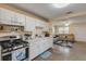 Kitchen with a view of the cozy living room with a large TV at 601 N Peninsula Ave, New Smyrna Beach, FL 32169