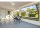 Relaxing screened lanai with outdoor seating and views of the lush backyard at 601 N Peninsula Ave, New Smyrna Beach, FL 32169