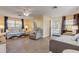 Living room featuring a sofa, armchair, and ample natural light at 601 N Peninsula Ave, New Smyrna Beach, FL 32169