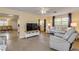 Living room with light flooring, a TV stand, and ample natural light at 601 N Peninsula Ave, New Smyrna Beach, FL 32169