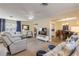 Bright living room with tile flooring, ceiling fan, and comfortable seating arrangements at 601 N Peninsula Ave, New Smyrna Beach, FL 32169