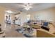 Open living room with a plush sectional sofa, ceiling fan, and seamless access to the kitchen at 601 N Peninsula Ave, New Smyrna Beach, FL 32169