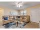 A comfortable living room featuring a plush sectional sofa, ceiling fan, and neutral decor at 601 N Peninsula Ave, New Smyrna Beach, FL 32169