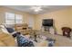 Comfortable living room with a large window, neutral walls, and cozy furniture at 601 N Peninsula Ave, New Smyrna Beach, FL 32169