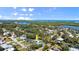 Expansive aerial shot capturing the home, surrounding greenery, and waterfront with stunning cityscape views at 61 E Bayshore Dr, Port Orange, FL 32127