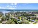 Aerial view of property showcasing the pool, surrounding trees, and neighborhood at 61 E Bayshore Dr, Port Orange, FL 32127