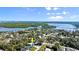 An aerial view showcases the coastal home's waterfront location and beautiful green surroundings at 61 E Bayshore Dr, Port Orange, FL 32127