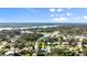 Wide aerial shot of the area, featuring many trees, neighborhood and the waterfront at 61 E Bayshore Dr, Port Orange, FL 32127
