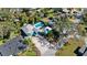 An aerial view of a home with a pool, circular driveway, and beautiful green surroundings at 61 E Bayshore Dr, Port Orange, FL 32127
