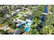 An aerial view of the neighborhood shows the turquoise home's pool and the nearby canal at 61 E Bayshore Dr, Port Orange, FL 32127