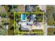Aerial view of home featuring a pool, lush landscaping, and waterfront at 61 E Bayshore Dr, Port Orange, FL 32127