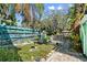 Landscaped backyard features a patio area and a colorful, decorative fence for added charm and privacy at 61 E Bayshore Dr, Port Orange, FL 32127