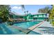 Backyard view of a beautiful in-ground pool, with a lovely deck and lots of greenery at 61 E Bayshore Dr, Port Orange, FL 32127