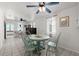 Bright dining area is adjacent to the living area and features tiled floors and two ceiling fans at 61 E Bayshore Dr, Port Orange, FL 32127
