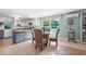 Eat-in kitchen featuring dining table, bright natural light and neutral tile floor at 61 E Bayshore Dr, Port Orange, FL 32127